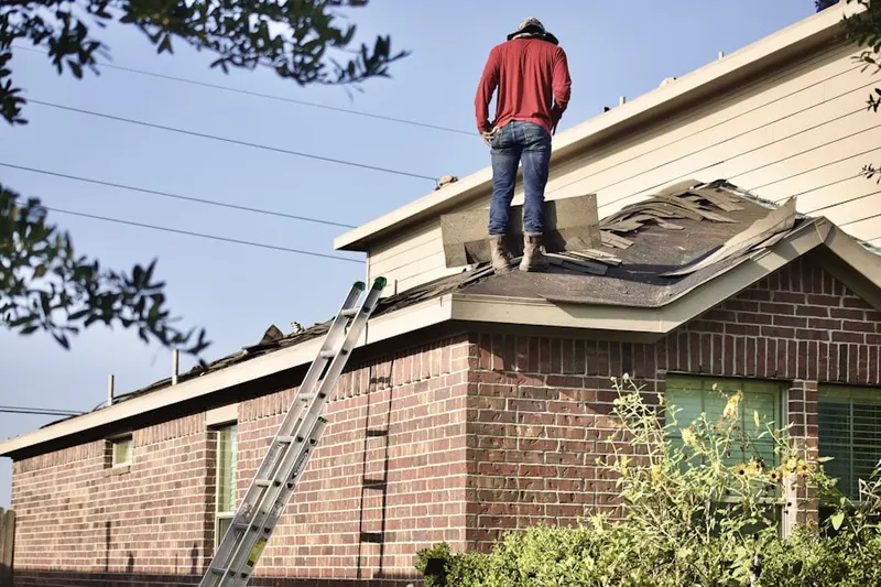 Professional roofer working on a residential roof in Manheim
